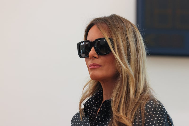 Former U.S. first lady Melania Trump looks on as Republican presidential nominee and former U.S. President Donald Trump (not pictured) speaks to reporters after voting at Mandel Recreation Center on Election Day in Palm Beach, Florida, U.S., November 5, 2024.