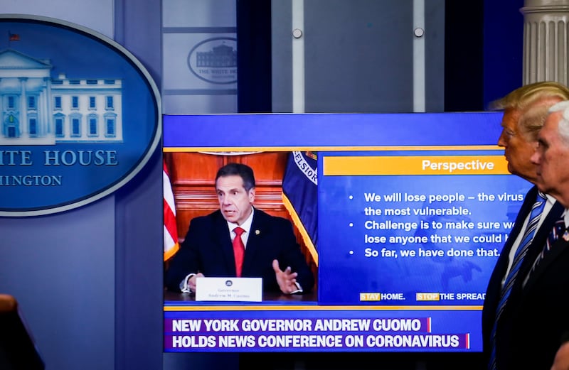 President Donald Trump and U.S. Vice President Mike Pence watch a video of New York governor Andrew Cuomo during the daily Covid-19 task force briefing at the White House in Washington, D.C. on April 19, 2020.