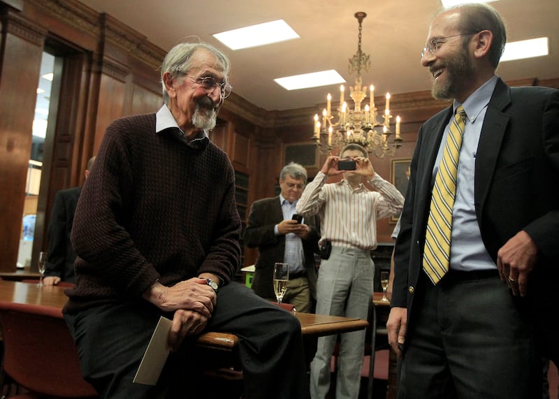 CAMBRIDGE, MA - OCTOBER 9: Harvard chemistry professor Martin Karplus, left, received a visit by Harvard University Provost Alan Garber, right, as Karplus was hosted by his colleagues at the Chemistry Library on October 9, 2013.