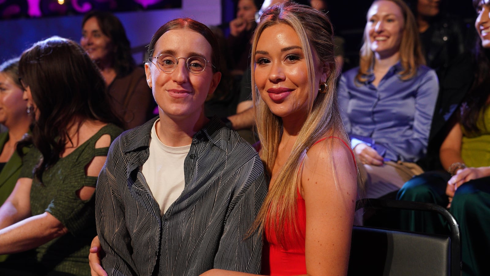 ROBBY HOFFMAN and GABBY WINDEY sit hand in hand.