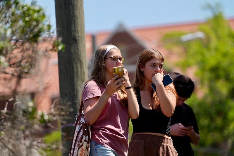 Evacuees watch law enforcement work on Florida State University (FSU) campus after a mass shooting in Tallahassee, Florida, U.S., April 17, 2025.