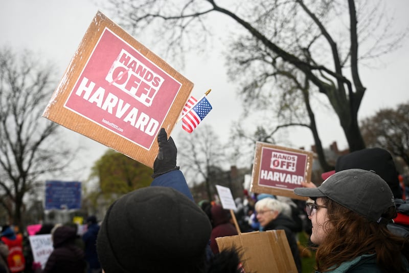 Demonstrators rally to call on Harvard leadership to resist interference at the university by the federal government.