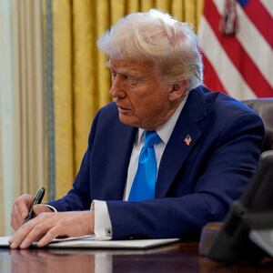 FILE PHOTO: U.S. President Donald Trump signs a document in the Oval Office at the White House in Washington, U.S. February 4, 2025. REUTERS/Elizabeth Frantz//File Photo