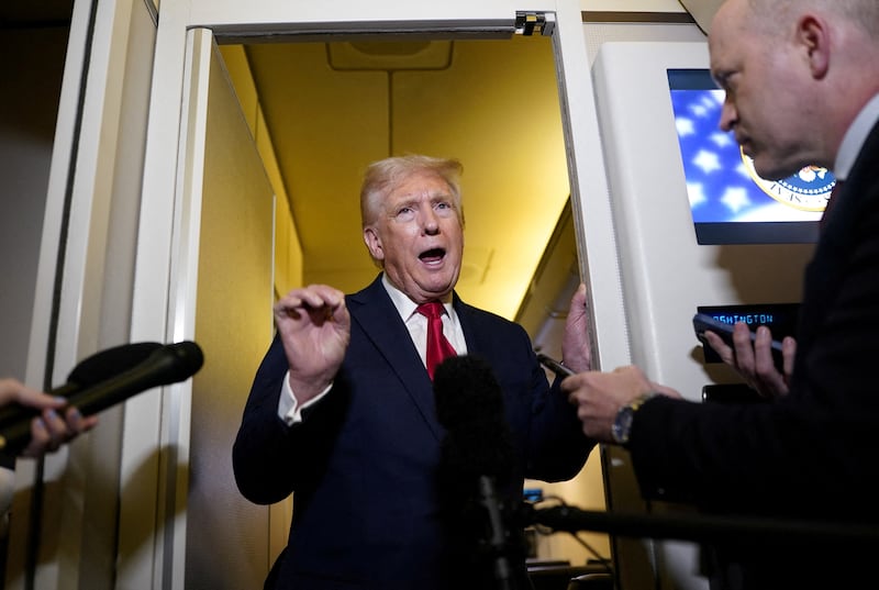 President Donald Trump speaks to members of the media onboard Air Force One on April 13, 2025.