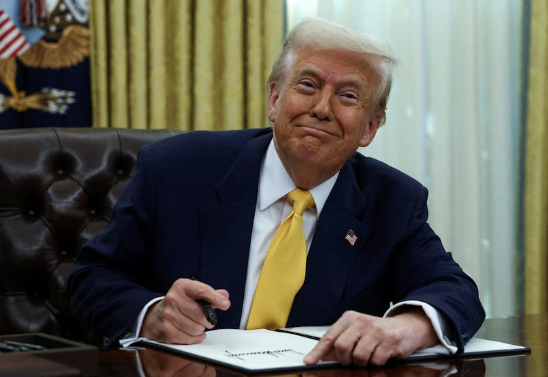 President Donald Trump signs an executive order in the White House Oval Office in Washington, D.C. on March 7, 2025.