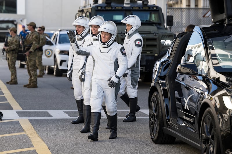 In this NASA handout, NASA astronauts Anne McClain and Nichole Ayers, JAXA (Japan Aerospace Exploration Agency) astronaut Takuya Onishi, and Roscosmos cosmonaut Kirill Peskov, wearing SpaceX spacesuits, are seen as they prepare to depart the Neil A. Armstrong Operations and Checkout Building for Launch Complex 39A on NASA's Kennedy Space Center to board the SpaceX Dragon spacecraft for the Crew-10 mission launch, Wednesday, March 12, 2025, at NASA's Kennedy Space Center in Florida.