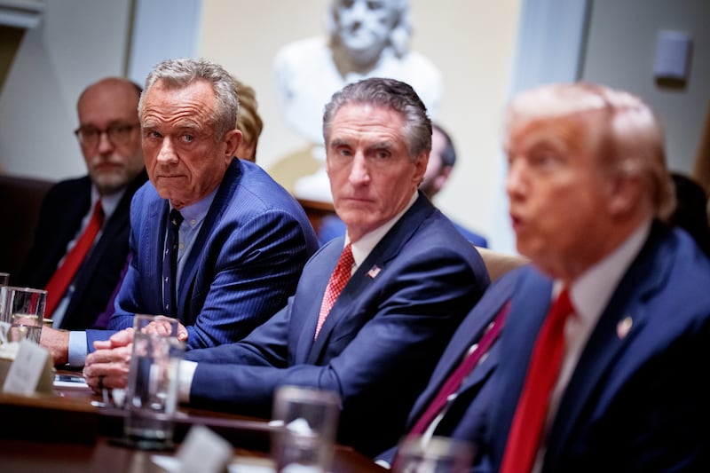 (L-R) Office of Management and Budget Director Russell Vought, U.S. Health and Human Services Secretary Robert F. Kennedy Jr., and Interior Secretary Doug Burgum, listen as U.S. President Donald Trump speaks during a Cabinet meeting at the White House on February 26, 2025 in Washington, DC.