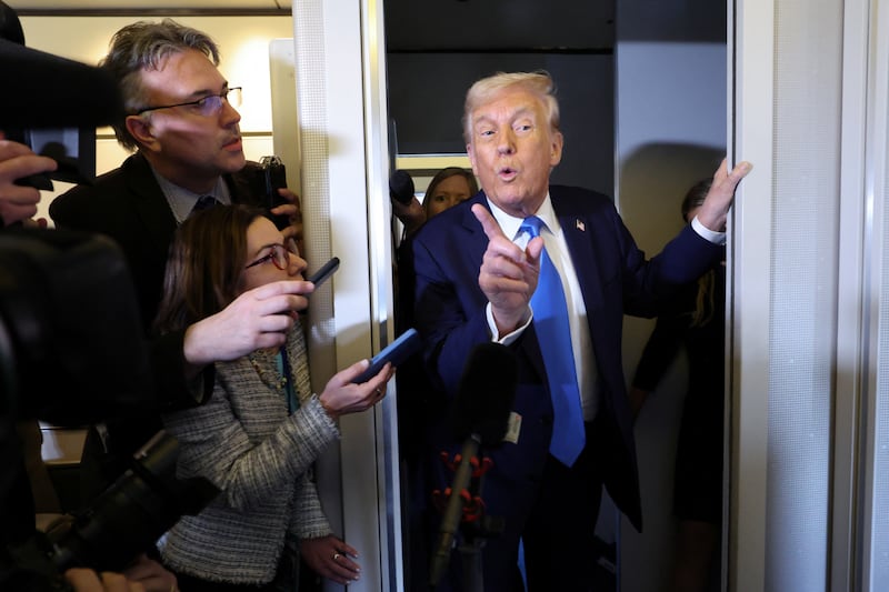 President Donald Trump speaks to members of the media aboard Air Force One before landing in West Palm Beach, Florida on March 28, 2025.