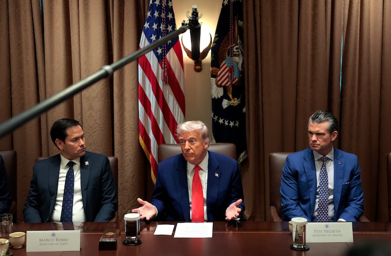 President Donald Trump (C) delivers remarks alongside Secretary of State Marco Rubio (L) and Secretary of Defense Pete Hegseth during a Cabinet meeting at the White House.