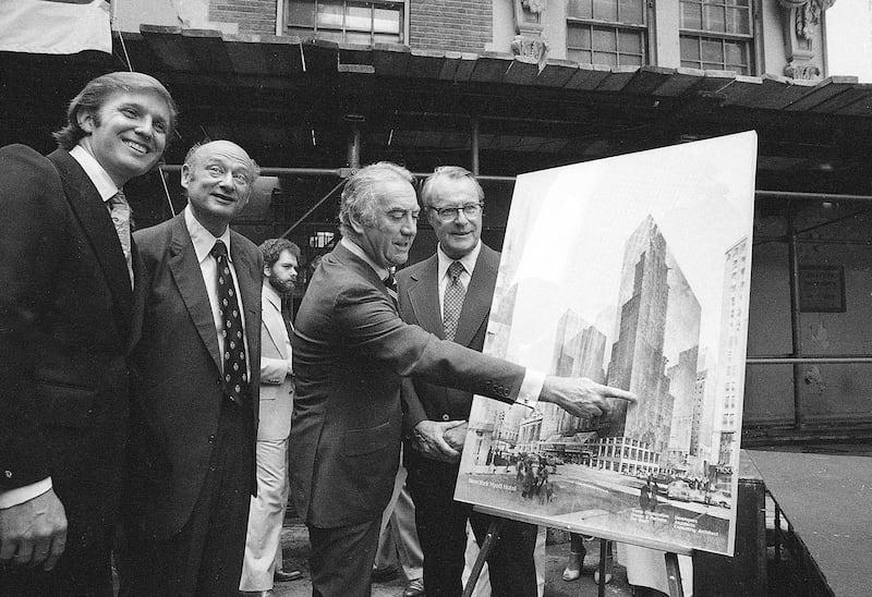 In this June 28, 1978, file photo, New York Gov Hugh Carey points to an artists' conception of the new New York Hyatt Hotel/Convention facility that will be build on the site of the former Commordore Hotel in New York. Now called the Grand Hyatt New York, the building that helped Donald Trump make a name for himself in his first big deal in Manhattan is being sold to developers who plan to tear it down. From left are: Donald Trump; New York Mayor Mayor Ed Koch; Carey; and Robert T. Dormer, executive vice president of the Urban Development Corp.