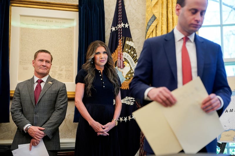 U.S. Department of Homeland Security Kristi Noem and U.S. National Security Advisor Mike Waltz stand near a copy of the Declaration of Independence, as U.S. President Donald Trump (not pictured) signs executive orders and proclamations, in the Oval Office at the White House in Washington, D.C., U.S., April 9, 2025. REUTERS/Nathan Howard