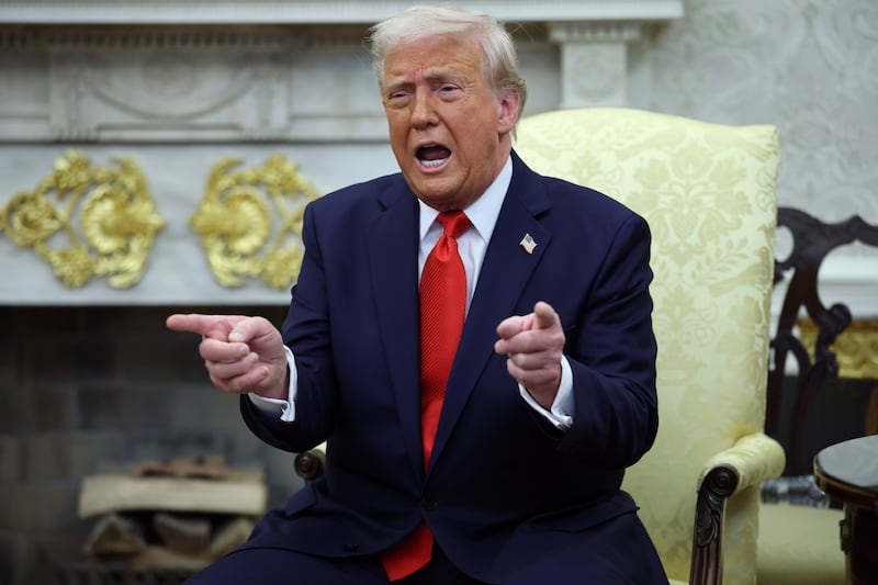 President Donald Trump gestures as he meets with President Nayib Bukele of El Salvador in the Oval Office of the White House to discuss his mass immigration crackdown.