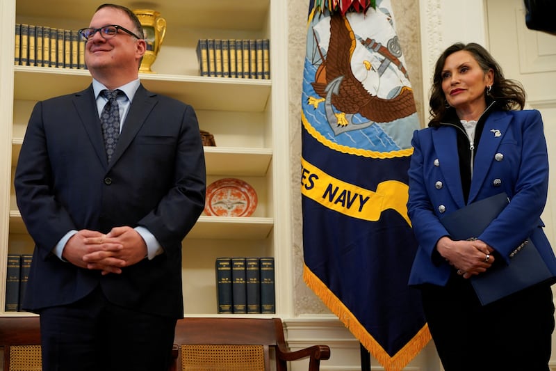 Michigan Governor Gretchen Whitmer stands next to Michigan House Speaker Matt Hall, as U.S. President Donald Trump (not pictured) signs executive orders and proclamations, in the Oval Office at the White House in Washington, D.C., U.S., April 9, 2025. REUTERS/Nathan Howard