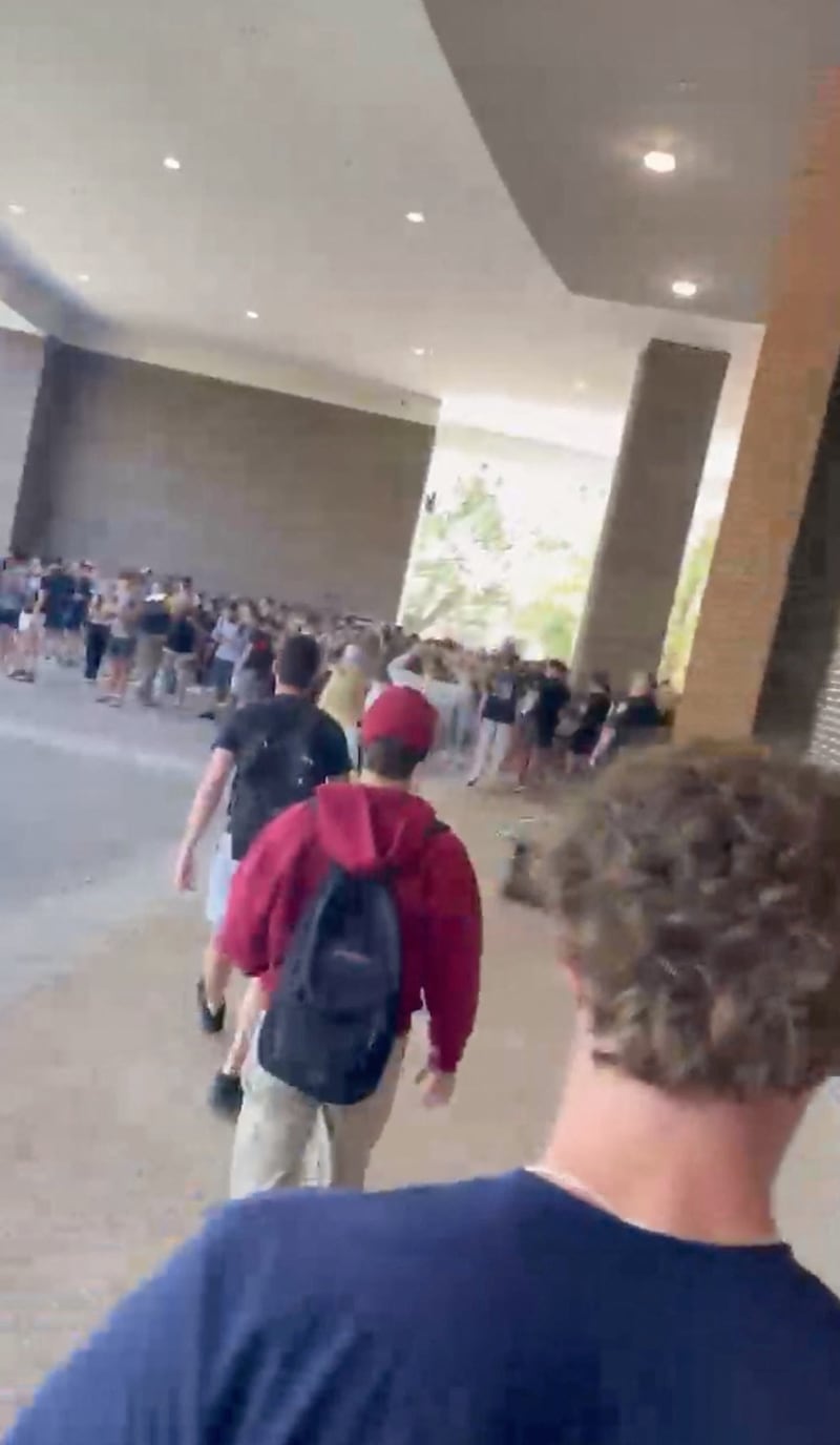 People gather as they are evacuated during a shooting at Florida State University.