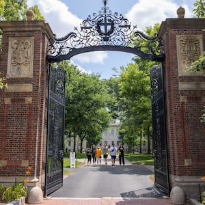 People walk through the gate on Harvard Yard at the Harvard University campus on June 29, 2023 in Cambridge, Massachusetts.