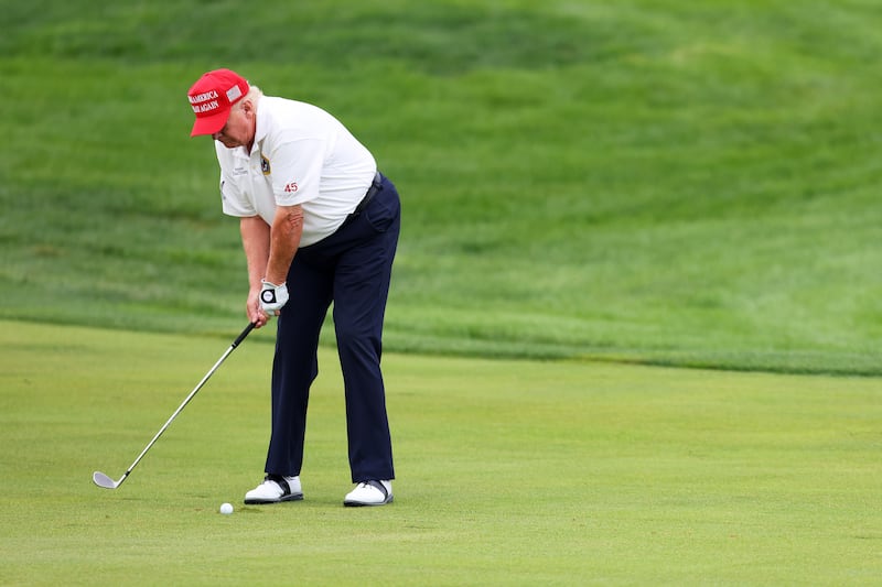 Former President Donald Trump hits his shot from the first fairway during the pro-am prior to the LIV Golf Invitational - Bedminster at Trump National Golf Club on August 10, 2023 in Bedminster, New Jersey.